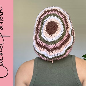 May include: A crocheted beanie with a multi-coloured striped pattern in shades of brown, pink, white, and green.