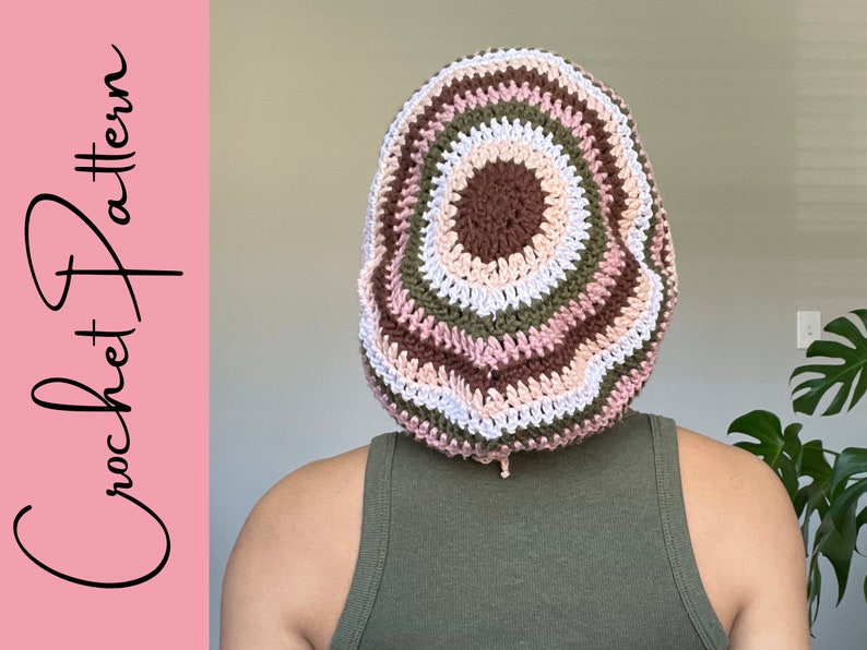 May include: A crocheted beanie with a multi-coloured striped pattern in shades of brown, pink, white, and green.