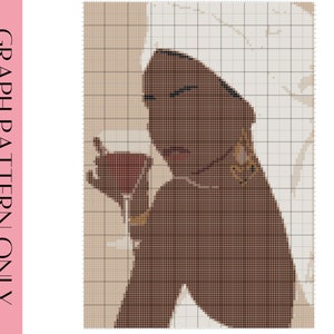 May include: A digital cross stitch pattern of a woman with a white towel on her head, holding a glass of red wine. She is wearing gold earrings and a gold bracelet. The background is a light beige color.