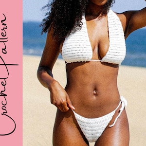 May include: White crochet bikini top and bottom with a halter style top. The bikini is shown on a person on a beach.