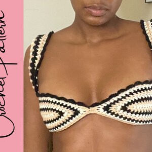 May include: A crocheted bikini top with black and beige stripes. The top has a scalloped edge and a sweetheart neckline.