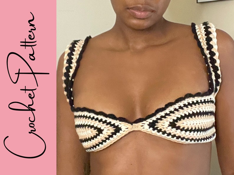 May include: A crocheted bikini top with black and beige stripes. The top has a scalloped edge and a sweetheart neckline.
