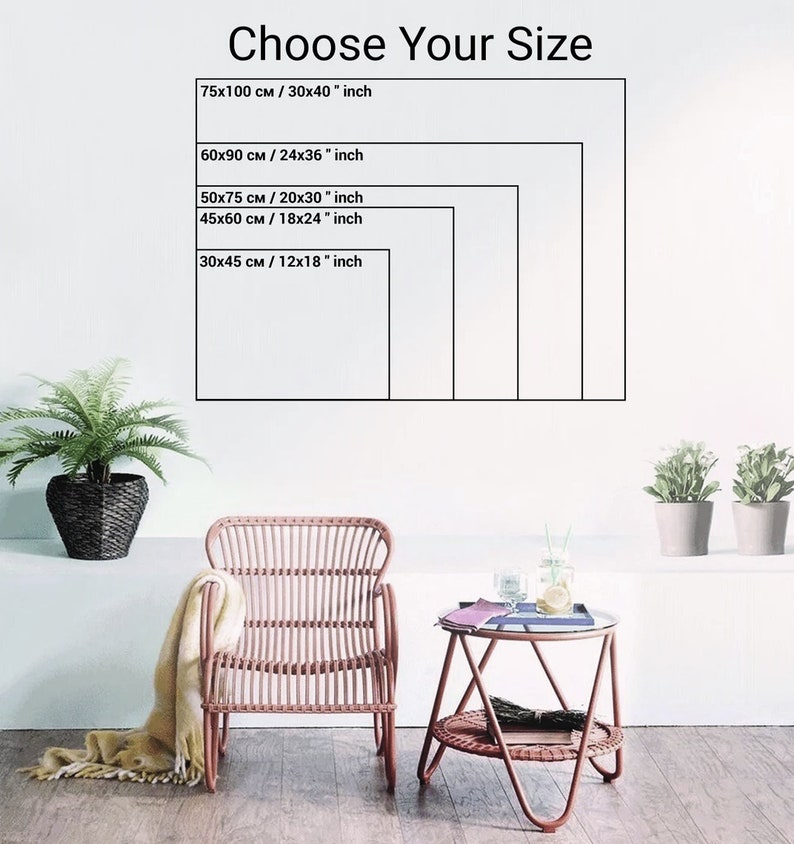 May include: The image displays a white wall with a framed size guide. The text "Choose Your Size" is at the top. The guide shows five rectangular frames with dimensions in both centimeters and inches, including 30x40 inches and 12x18 inches. A wicker chair and side table are in the foreground.