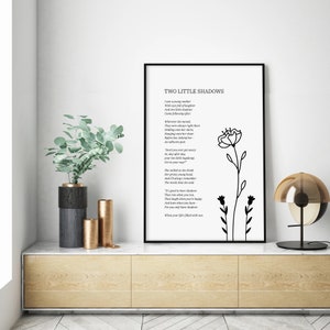 May include: Black and white printable wall art featuring a poem titled "Two Little Shadows" with a simple line drawing of two flowers. The poem reads: "I saw a young mother with two little shadows..."