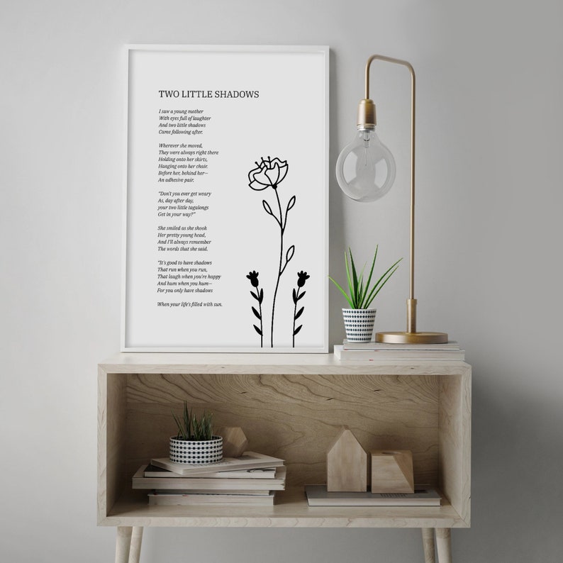 May include: A black and white printable art print with a poem titled "Two Little Shadows" about a young mother and her daughter. The poem is printed on a white background with a black floral illustration.