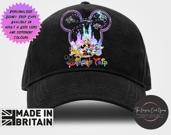 May include: A black baseball cap featuring a graphic of Mickey Mouse and friends in front of a castle silhouette. The text "Disney Trip" appears below the characters. A pink starburst graphic contains the text "PERSONALISED DISNEY TRIP CAPS AVALIBLE IN ADULT & KIDS SIZES AND DIFFERENT COLOURS".