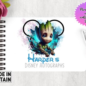 May include: A white A6 autograph book with a blue and green illustration of a character from the Guardians of the Galaxy movie. The character is surrounded by a blue and purple watercolor background. The book has a Mickey Mouse ear design and the text "Harper's Disney Autographs" in blue.