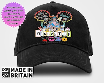 May include: A black baseball cap featuring a colorful graphic of a castle, fireworks, and various cartoon characters. The text reads Disney Trip 2026. Above the graphic, a pink starburst shape contains the text Personalised Disney Trip Caps Avaliable In Adult & Kids Sizes And Different Colours. A Made In Britain logo is at the bottom.