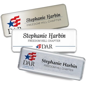 May include: Three rectangular name badges with rounded corners. The top badge is silver with a red, white, and blue flag graphic, the name Stephanie Harbin, and Freedom Hill Chapter. The middle is white with the name, chapter, and DAR logo. The bottom is brushed silver with the DAR logo and name.