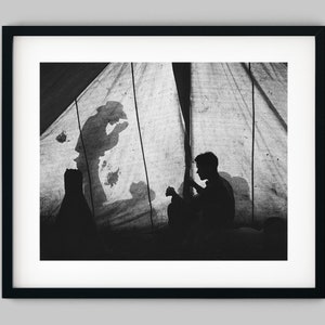 Cowboys make shadow silhouettes on a tent during dinner on a Ranch in Montana USA