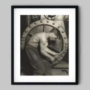 Male mechanic worker hold a wrench by a steel steam pump in a factory Black and White Photography Fine Art Print - Wall Decor