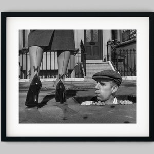 Man in a sewer looks out at a pretty lady in nylon stockings Black and White Photography Fine Art Print - Wall Decor