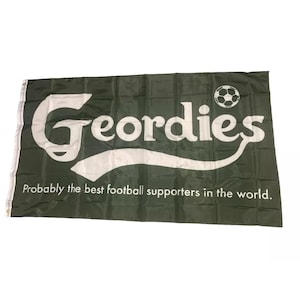 May include: A green flag with white text that reads "Georddies" and a white football. The text is in a curved font and the flag says "Probably the best football supporters in the world."