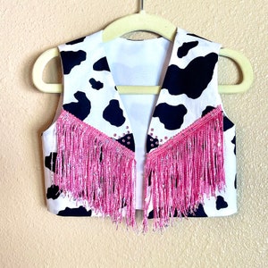 Girls rhinestone accent black and white or pink cowhide print vest with sequin fringe.
