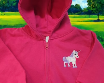 May include: A pink zip-up hoodie with a purple unicorn embroidered on the front.