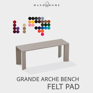 May include: A light gray bench with a rectangular top and four legs. The bench is labeled "GRANDE ARCHE BENCH FELT PAD." Above the bench are color swatches in various shades. The logo "MANDOHOME" is at the top.