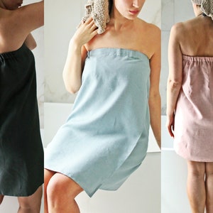 May include: Three bathrobes in different colours, one dark green, one light blue and one light pink. The robes are made from a soft, absorbent material and are ideal for wrapping up after a bath or shower.