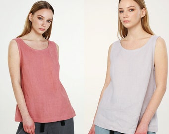 May include: Two sleeveless linen tops, one in a dusty rose color and the other in a light lavender color. Both tops have a scoop neck and a relaxed fit.