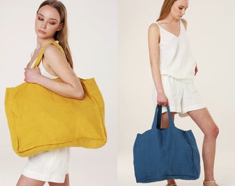 May include: Two large tote bags made of linen. One bag is yellow and the other is blue.