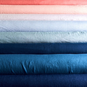 May include: A stack of fabric rolls in various shades of blue, green, pink, and red. The fabric is a linen blend and has a textured surface.