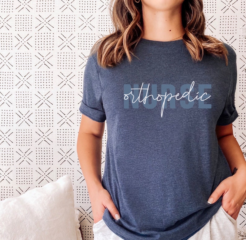 May include: A dark blue t-shirt with the text "orthopedic nurse" printed in white on the front.