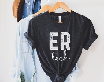 May include: A dark gray t-shirt with white text that reads "ER tech" in a distressed font.