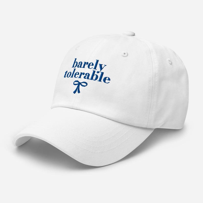 May include: White baseball cap with the text "barely tolerable" in blue lettering and a blue bow.