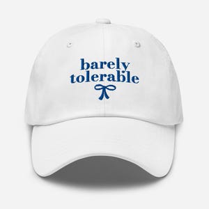 May include: White baseball cap with blue embroidery that reads "barely tolerable" with a blue bow underneath.