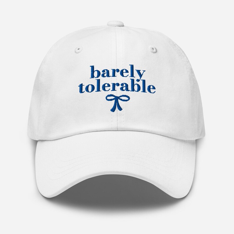 May include: White baseball cap with blue embroidery that reads "barely tolerable" with a blue bow underneath.