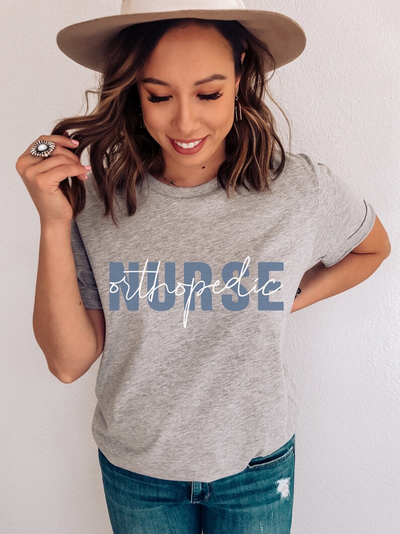 May include: A gray t-shirt with the text "orthopedic NURSE" in blue lettering. The text "orthopedic" is written in a cursive font.