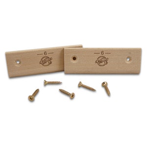 May include: Two wooden climbing holds with a 6 engraved on them. The holds are light brown and have a small hole in the center. Five gold screws are included.