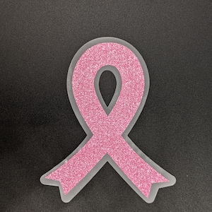 May include: Pink glitter ribbon awareness symbol.