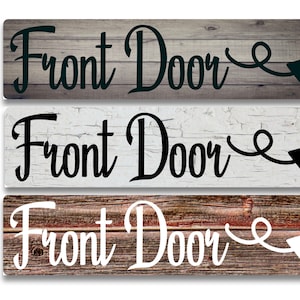 May include: Three wooden signs with the text "Front Door" and a black arrow pointing to the right. The signs have different wood grain patterns and the text is in black and white.