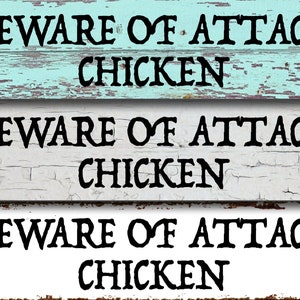 May include: Three rustic wooden signs with the text "Beware of Attack Chicken" in black lettering. The signs are painted in shades of blue and white with a distressed finish.