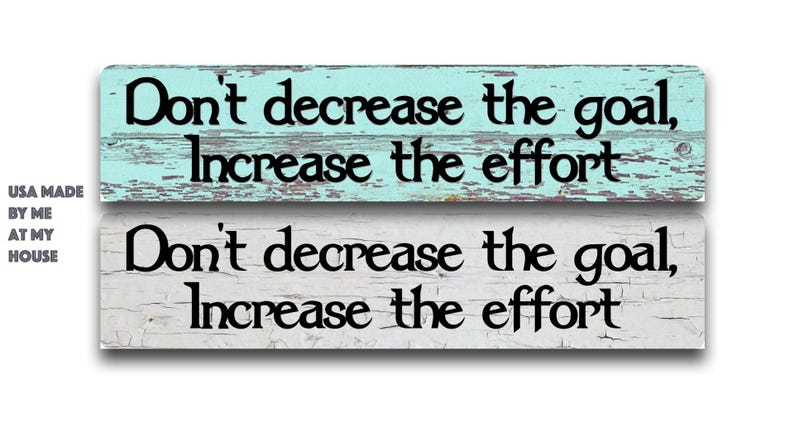 May include: Two wooden signs with the text "Don't decrease the goal, Increase the effort" in black. One sign is light blue, the other is white. The signs are made in the USA.