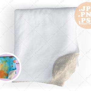 May include: A white fleece blanket with a soft, fluffy texture. The blanket is folded in half and has a white background with a subtle pattern. The blanket is a smart object, meaning it can be easily customized with different designs and colors.
