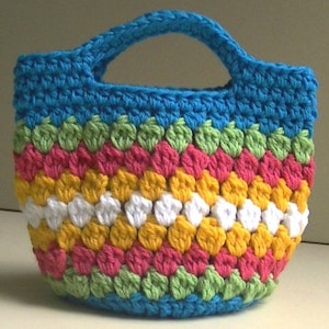 May include: A colorful crocheted tote bag with a blue handle and stripes of green, pink, yellow, and white.