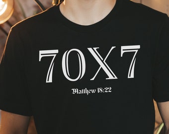 Puede incluir: Camiseta negra con texto blanco que dice "70X7 Mateo 18:22".