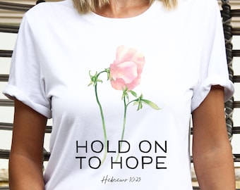 May include: White t-shirt with a watercolor illustration of a pink flower and the text "HOLD ON TO HOPE Hebrews 10:23".