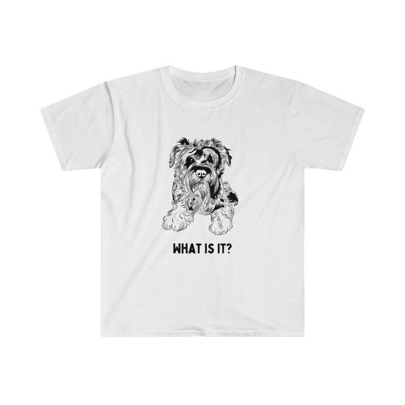May include: White t-shirt with a black and white illustration of a small dog with the text "WHAT IS IT?" printed below the image.