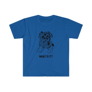 May include: A blue t-shirt with a black and white illustration of a dog and the text "WHAT IS IT?"