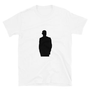 May include: A white t-shirt featuring a black silhouette of a person in a suit.
