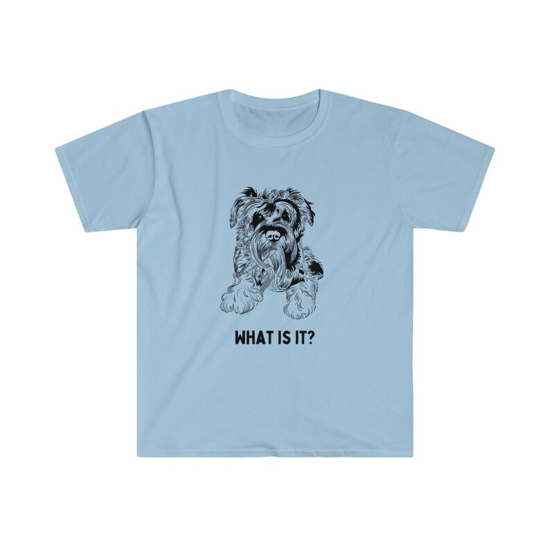 May include: A light blue t-shirt with a black and white illustration of a dog. The text "WHAT IS IT?" is printed below the image.