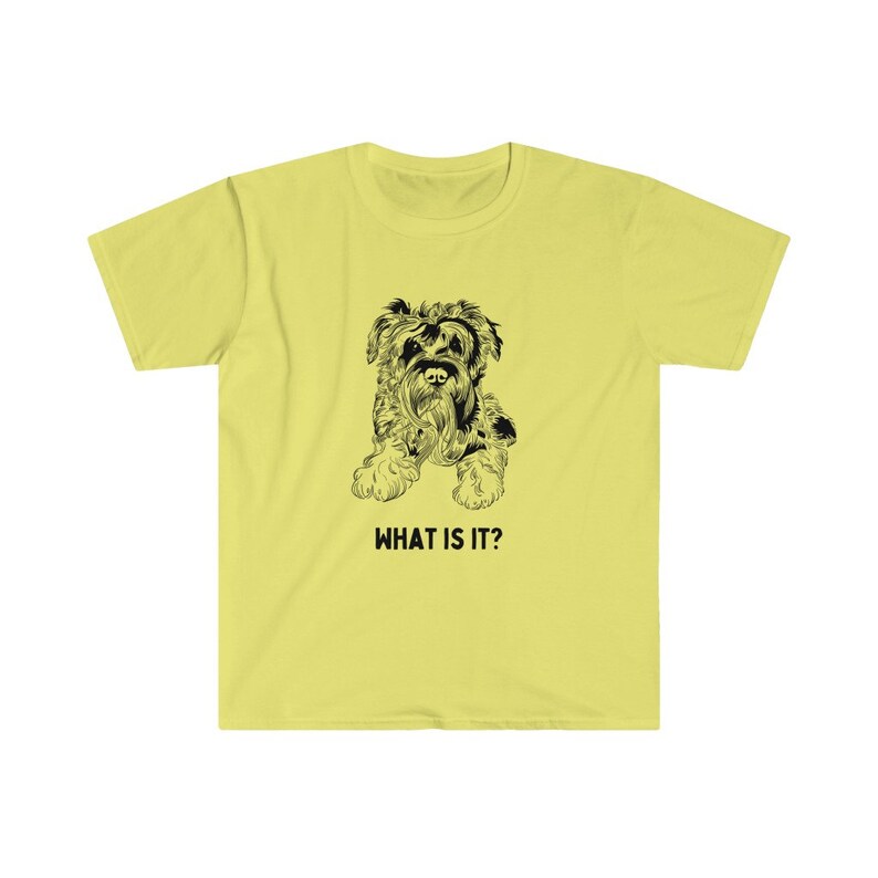 May include: A yellow t-shirt with a black and white illustration of a dog. The text "WHAT IS IT?" is printed below the dog.