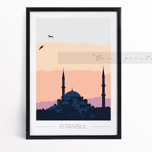 May include: Framed art print featuring a stylized illustration of Istanbul's skyline at sunset. The artwork showcases a mosque with two minarets, set against a gradient sky of orange, pink, and gray. The word "ISTANBUL" is printed at the bottom.