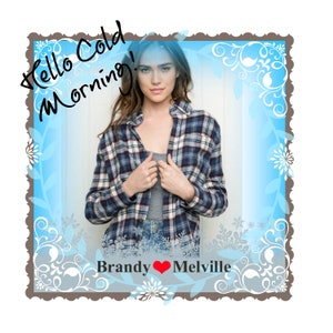 May include: A woman wearing a blue and red plaid shirt with the text "Hello Cold Morning!" written in black on a blue background. The text "Brandy ♥ Melville" is written below the woman.