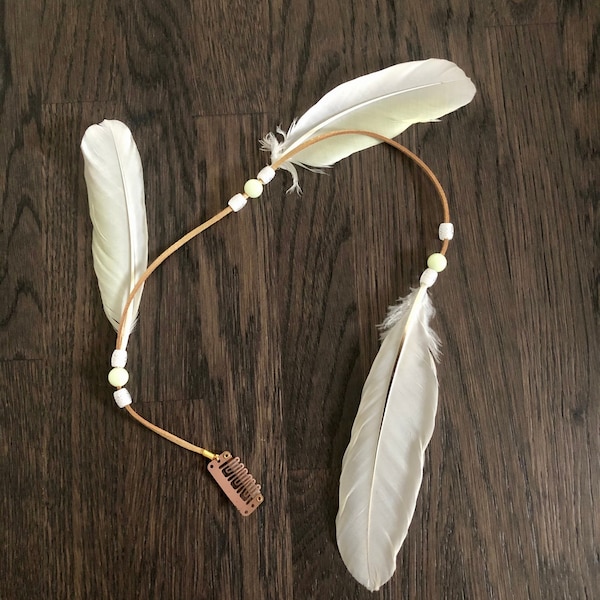 Feather hair extension with glow-in-the-dark beads