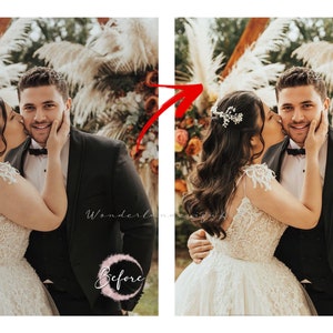 May include: A bride in a white lace wedding dress kisses the groom on the cheek. The groom is wearing a black suit and a white bow tie. They are standing in front of a floral archway.