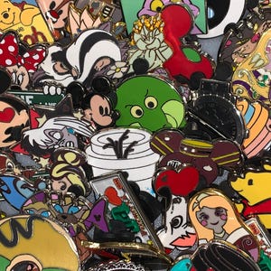 May include: A collection of colorful enamel pins featuring various cartoon characters. The pins showcase a variety of designs, including Mickey Mouse, Minnie Mouse, and other Disney characters. The pins are in various shapes and sizes, with vibrant colors and intricate details.