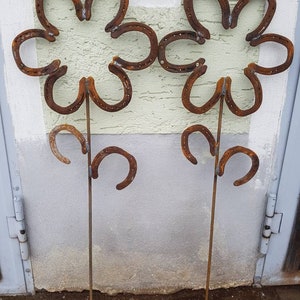 2 flowers made from old horseshoes